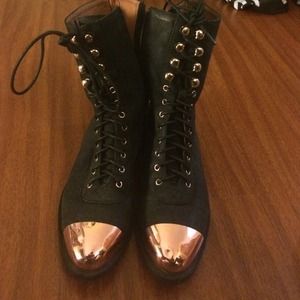 Rose gold tipped black boots.