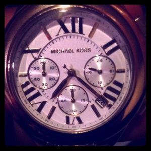 Micheal Kors female gold plated wrist watch.