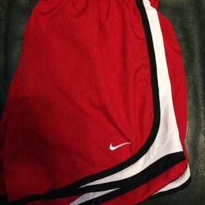 Red nike shorts with black and white sides.