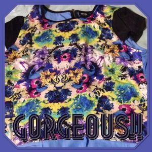 Floral top with blue back and black sleeves.