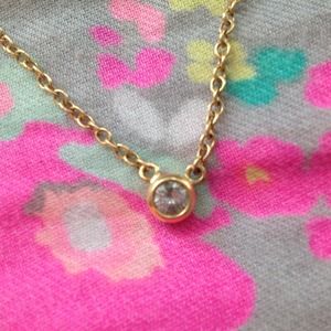 Gold necklace with diamond charm.