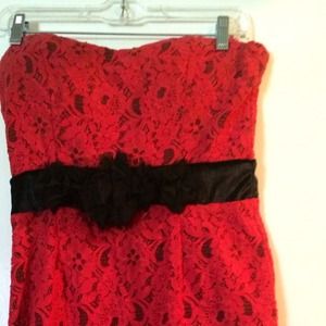 Red & black strapless lace dress .
