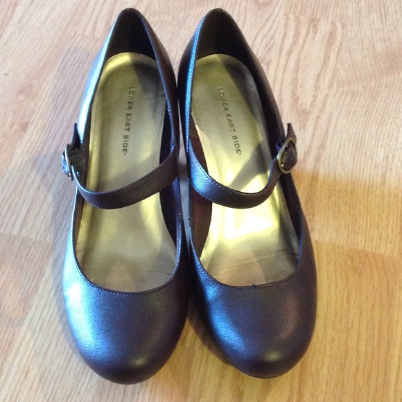Dark Brown Mary Jane style low heel shoes.