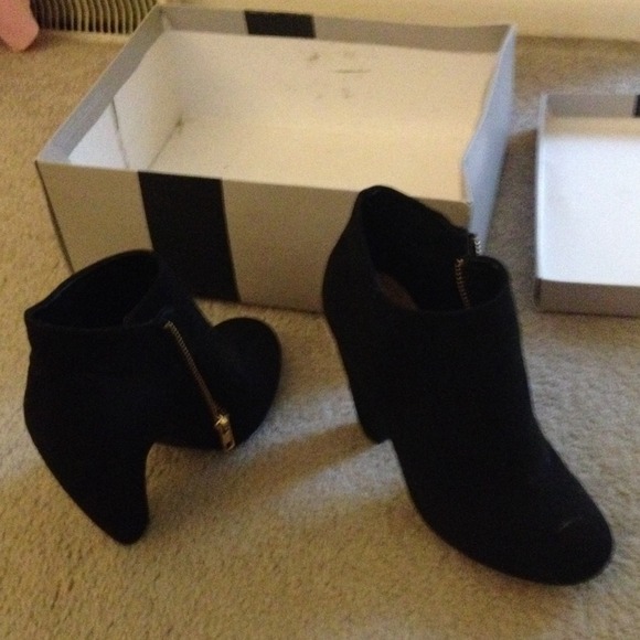 Black heeled boots. With a zipper on the side .