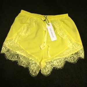 Neon yellow shorts with lace trim. NWT.