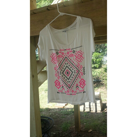 A flowy white over sized shirt with cute details.