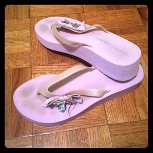 Variety of pink toned flip flops with now & jewels