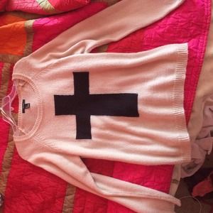 Long sleeve creme sweater with a black cross