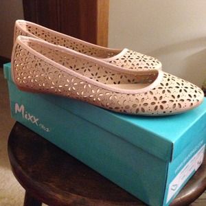 Nude flats with eyelet cutouts.