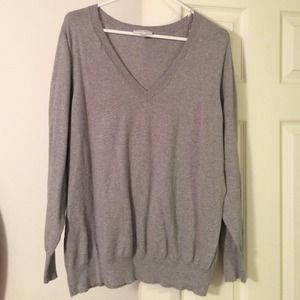 Grey V neck sweater.