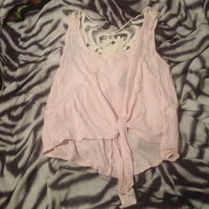A light pink belly shirt with a sort of lace back