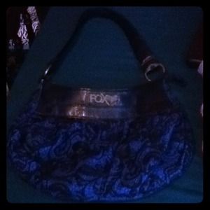 This is a blue purse with designs