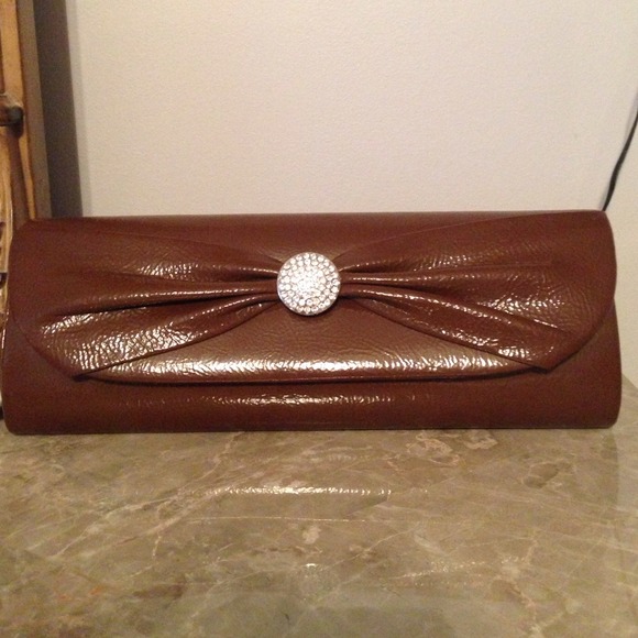 Brown clutch bag with design in the middle