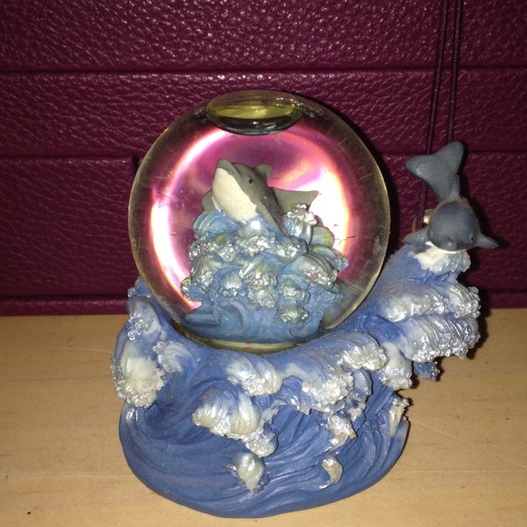 Dolphin snow globe and orange digital watch