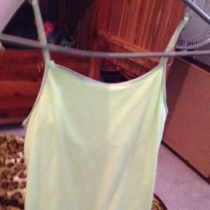A green tank top that is cropped a little