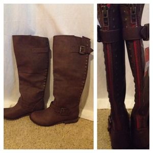 Knee-high brown leather boots.