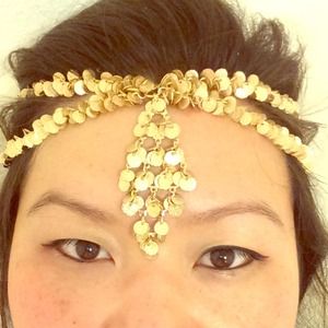 Gold beaded forehead band.