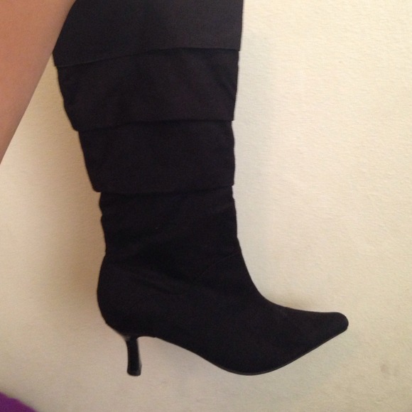 Black pointed toe heel boot with ruffle