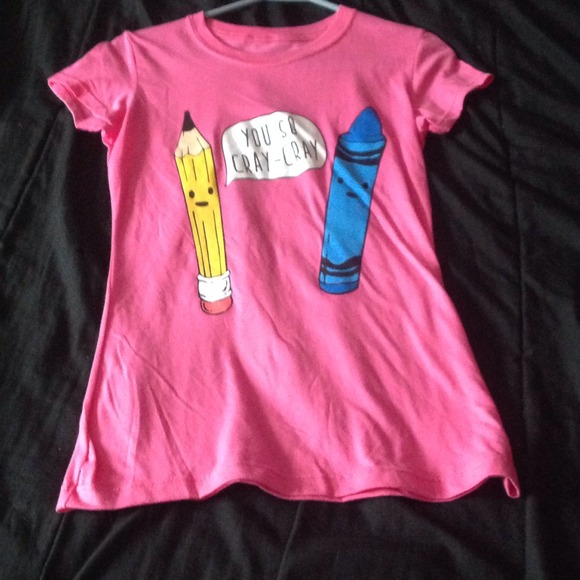 A shirt with a pencil and a crayon on the front.