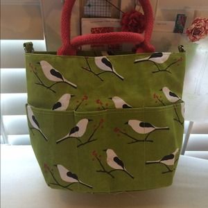 Green tote with white birds and red handles