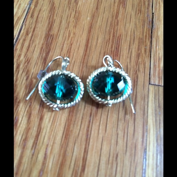 Emerald colored stone earrings with gold halo