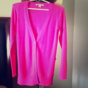 Bright pink cardigan.