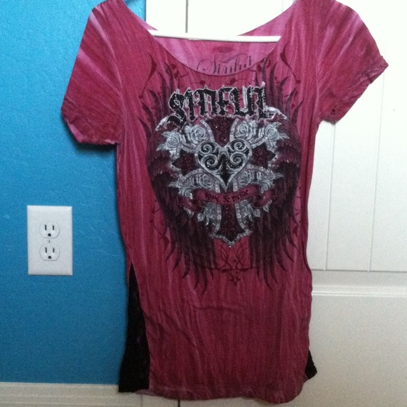 A red shirt with a washed like pattern from buckle