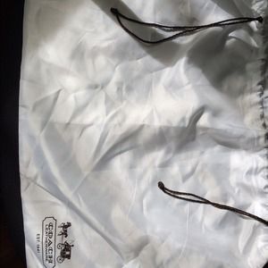Authentic Coach dust bag in white .