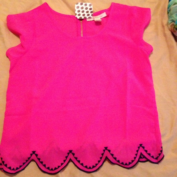 Hot pink scalloped blouse.