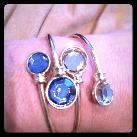 Gold toned bracelets with gems.