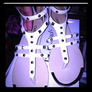 Carrini white studded gladiator sandals.