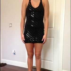 A black sequenced criss cross cocktail dress