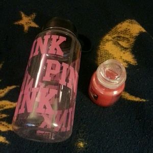A Victoria's secret water bottle and a Yankee cand
