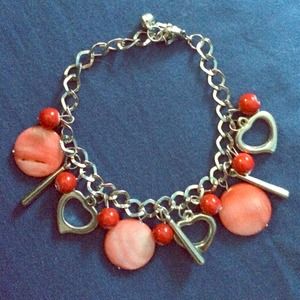 Silver chain with red and pink beading.