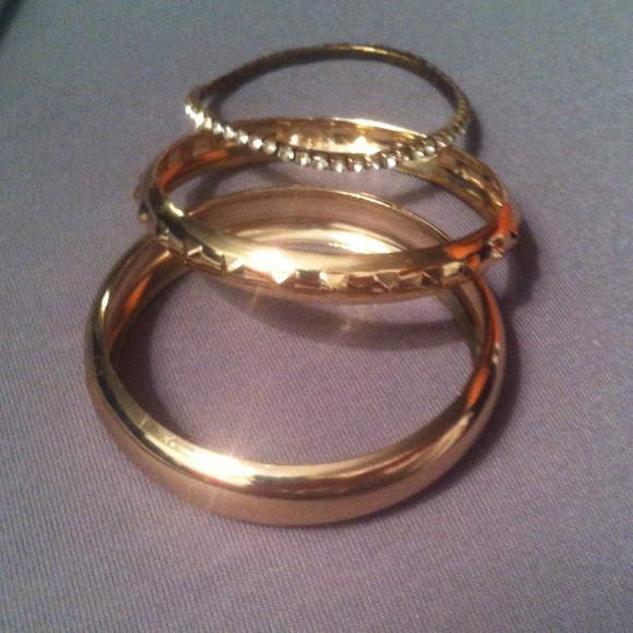 Two gold bangles one stretch diamond bracelet.