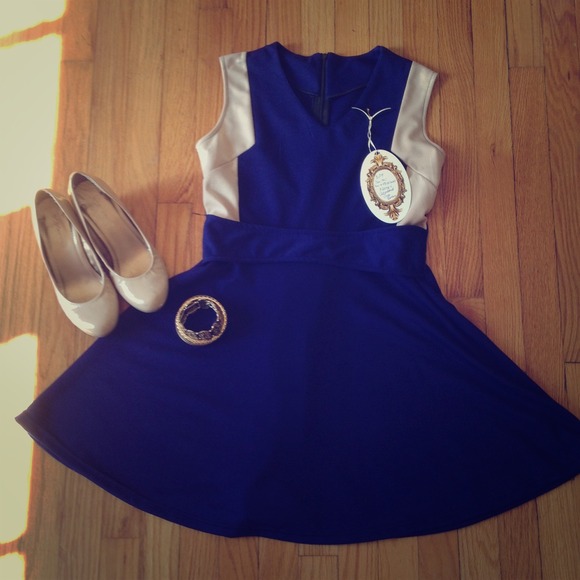 Navy blue dress with tan accents.