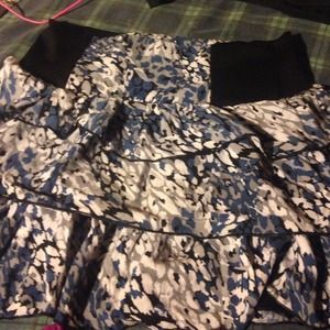 A blue, gray, black, and white ruffled mini skirt.