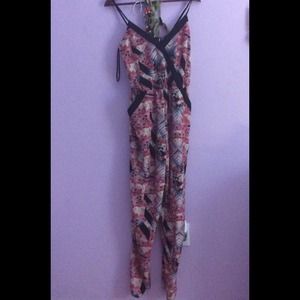 A jumpsuit with pink black and hints of blue