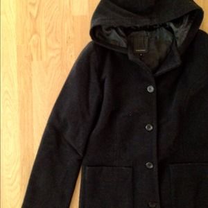 A long black winter coat with a hoodie