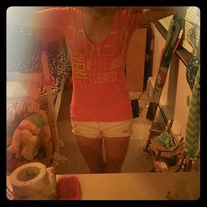 Peach colored american eagle v neck shirt.