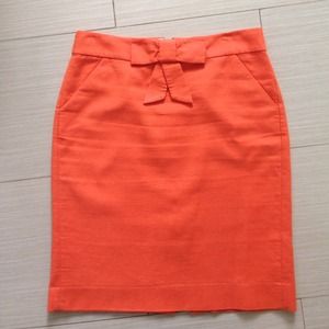 Charming tangerine orange skirt with now detail