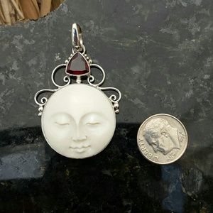 Hand carved sun face and garnet pendant