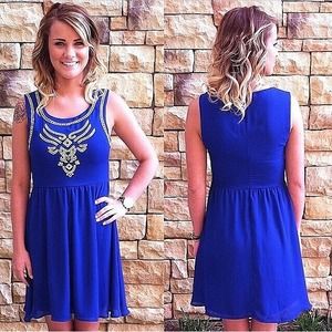 Royal blue dress with neon embroidered accent.