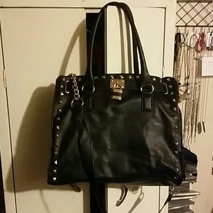 Black crossbody bag with gold chains and lock