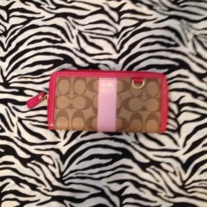 COACH Pink Heritage Stripe zip around wallet.