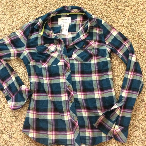 Plaid button up top and Vera Bradley ID wallets