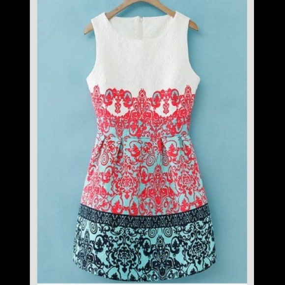 White dress with pink teal and navy design.