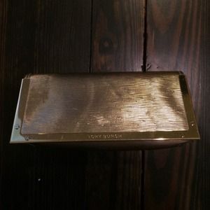 Gold Tory Burch make up bag