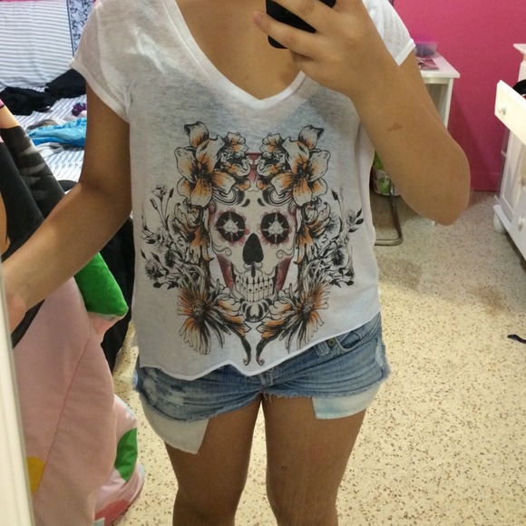 A white shirt with a skull figure