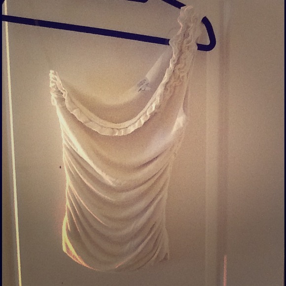 One shoulder white top.